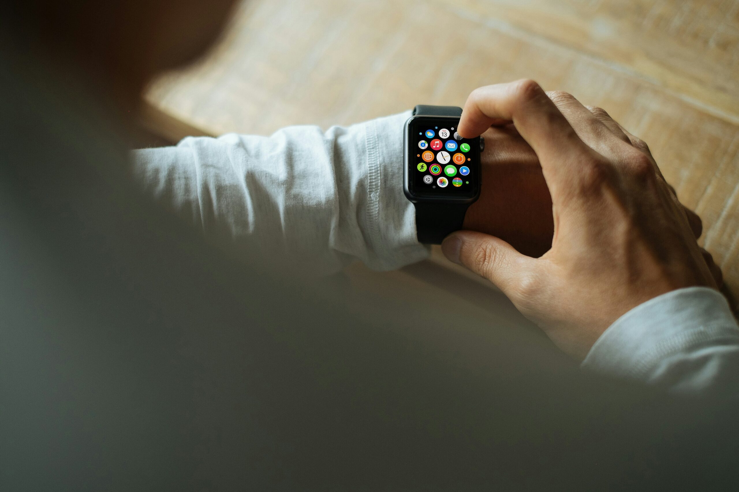 Person wearing a smartwatch working at a desk